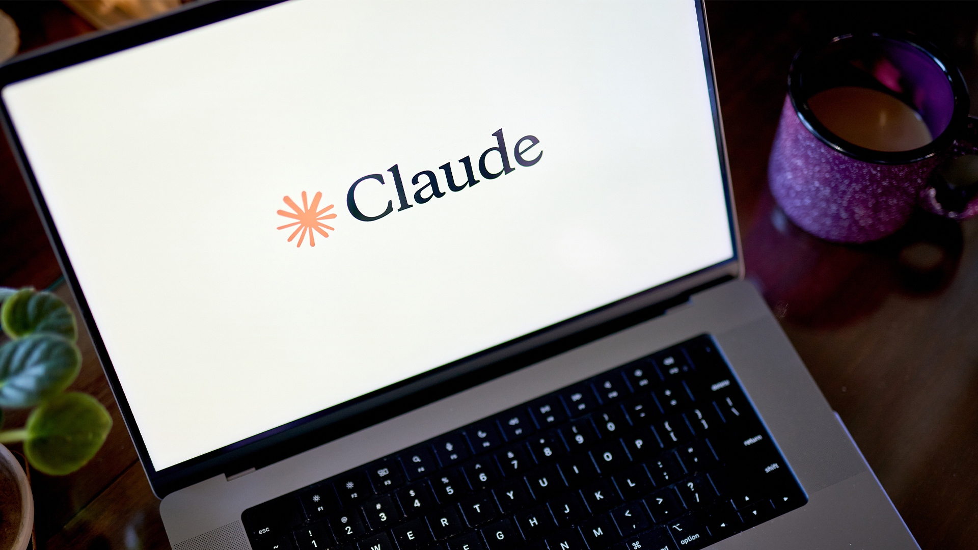 Logo and branding for Claude Code, developed by Ai company Anthropic, pictured on a laptop screen.