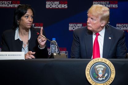 President Donald Trump speaks alongside Evelyn Rodriguez (L), whose daughter was killed by MS-13 gang members.