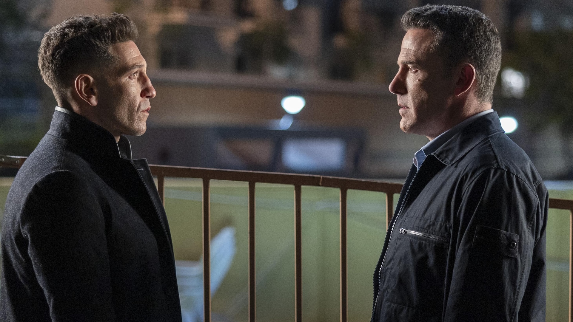 Jon Bernthal looking at Ben Affleck on a balcony in The Accountant 2