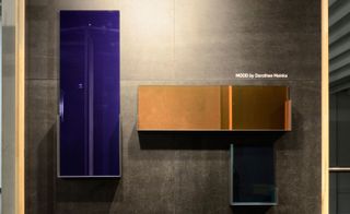 mirror collection with reflective metal shelves that embrace a coloured mirror face