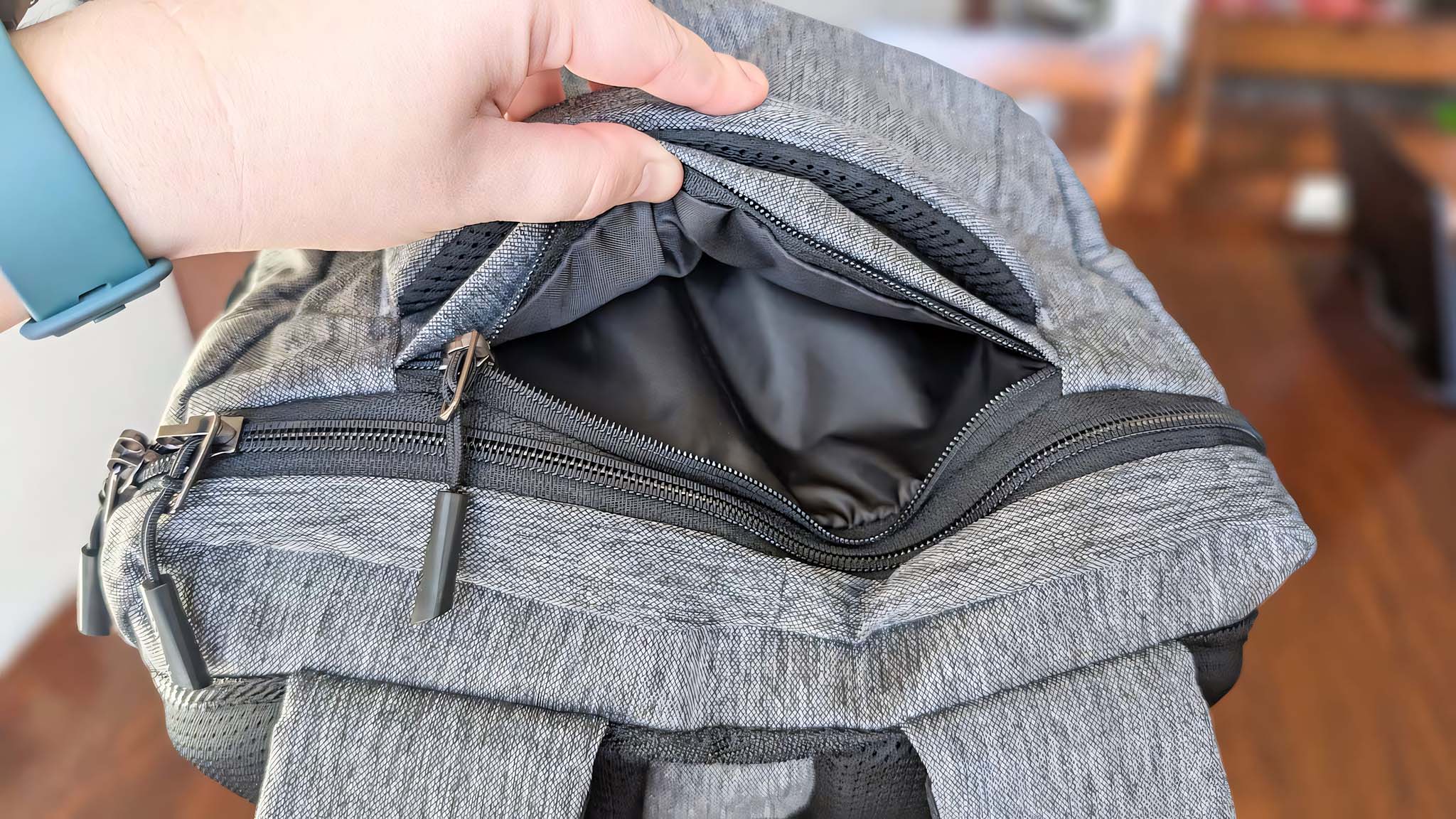 Tomtoc Navigator-T66's top pocket being opened by a hand.