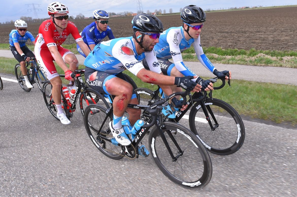 Several Israel Cycling Academy riders chase after a crash