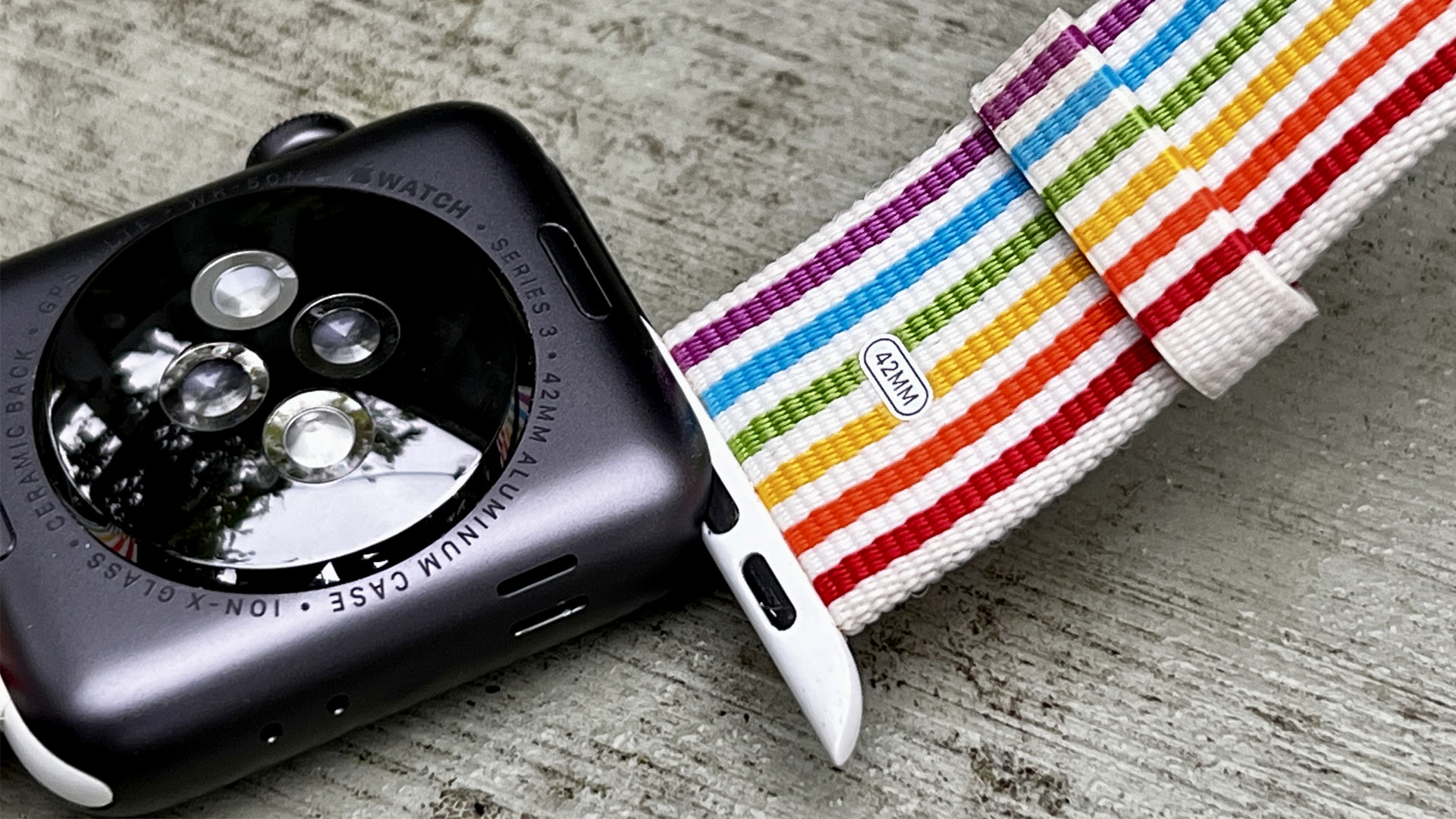 Image shows the bracelet of an Apple Watch 3 being inserted onto the watch.