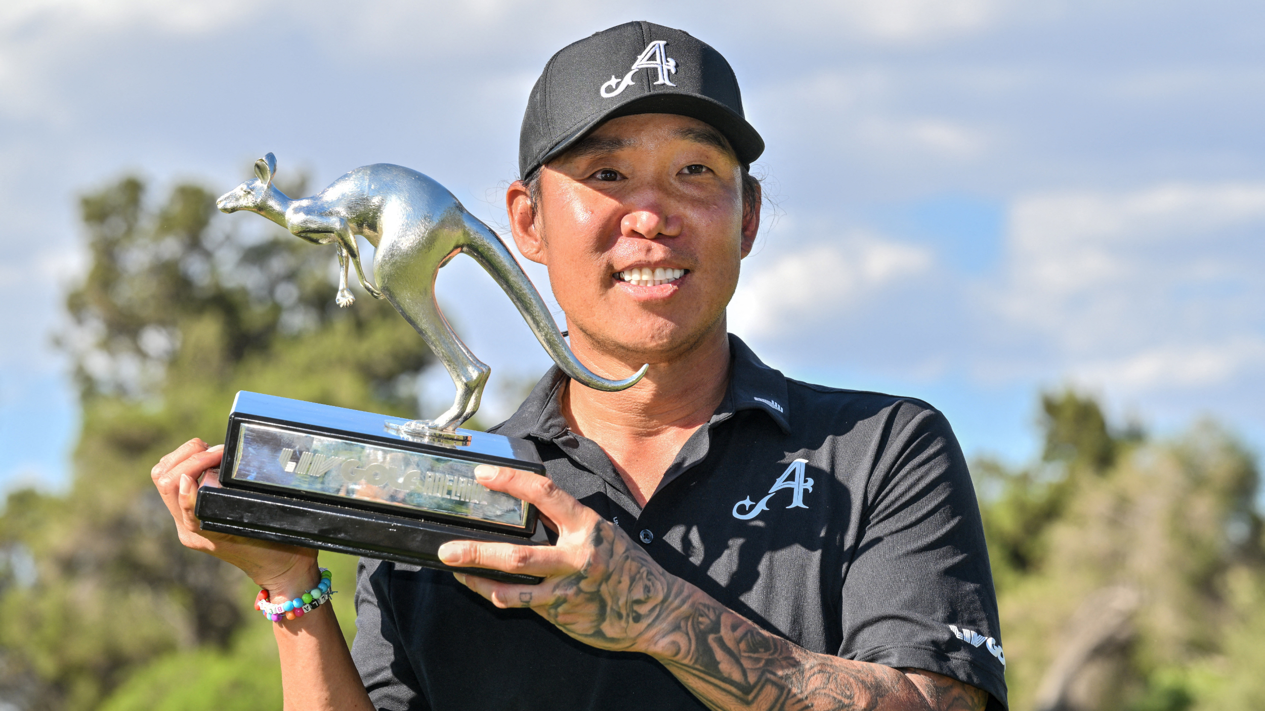 Anthony Kim poses for a photograph with the LIV Golf Adelaide trophy