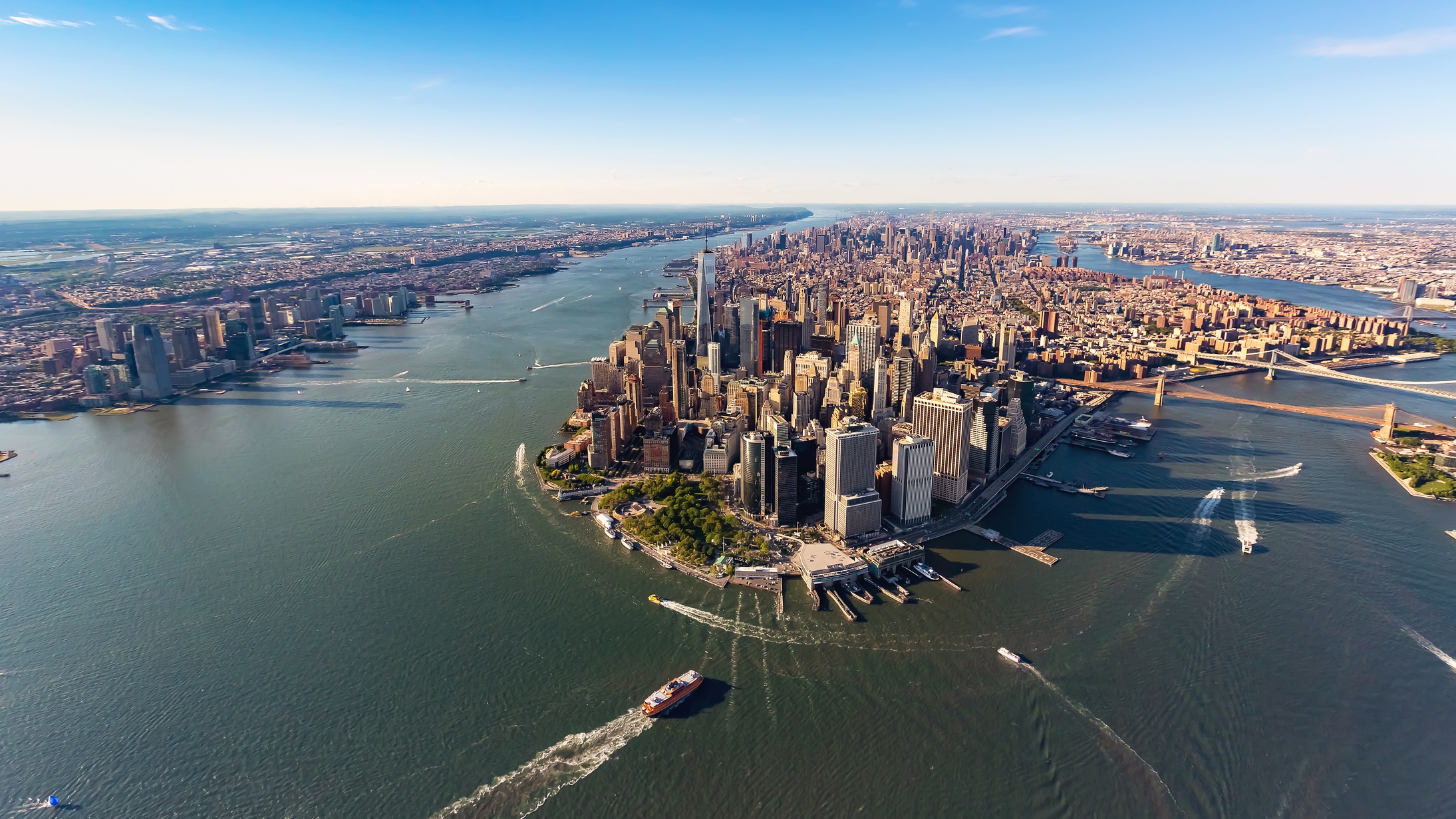 An aerial view of NYC with water around it.