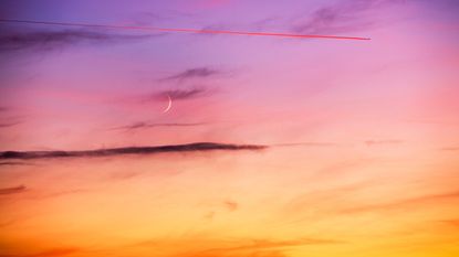 October New Moon—New Moon and plane contrail at sunset near Windermere, UK.