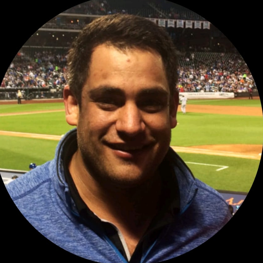 a headshot photo of locksmith CEO Steven Grunstein in a blue zip up sweater at a sports game