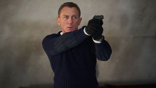 James Bond as played by Daniel Craig holding gun in No Time To Die