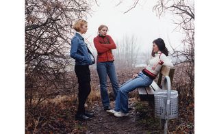 3 women in a wooded area