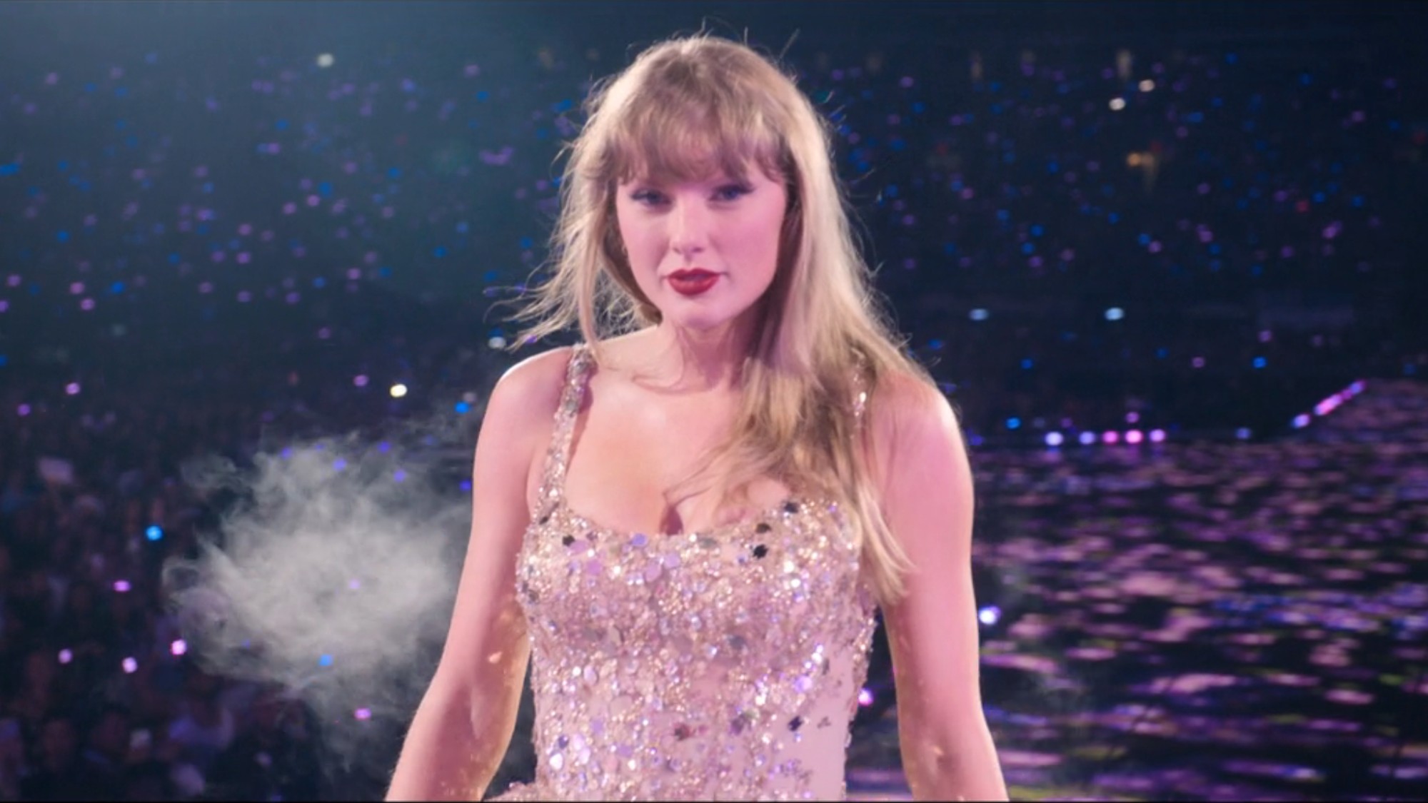 Taylor Swift walking down the stage and looking into the camera while performing Enchanted during the Eras Tour. 