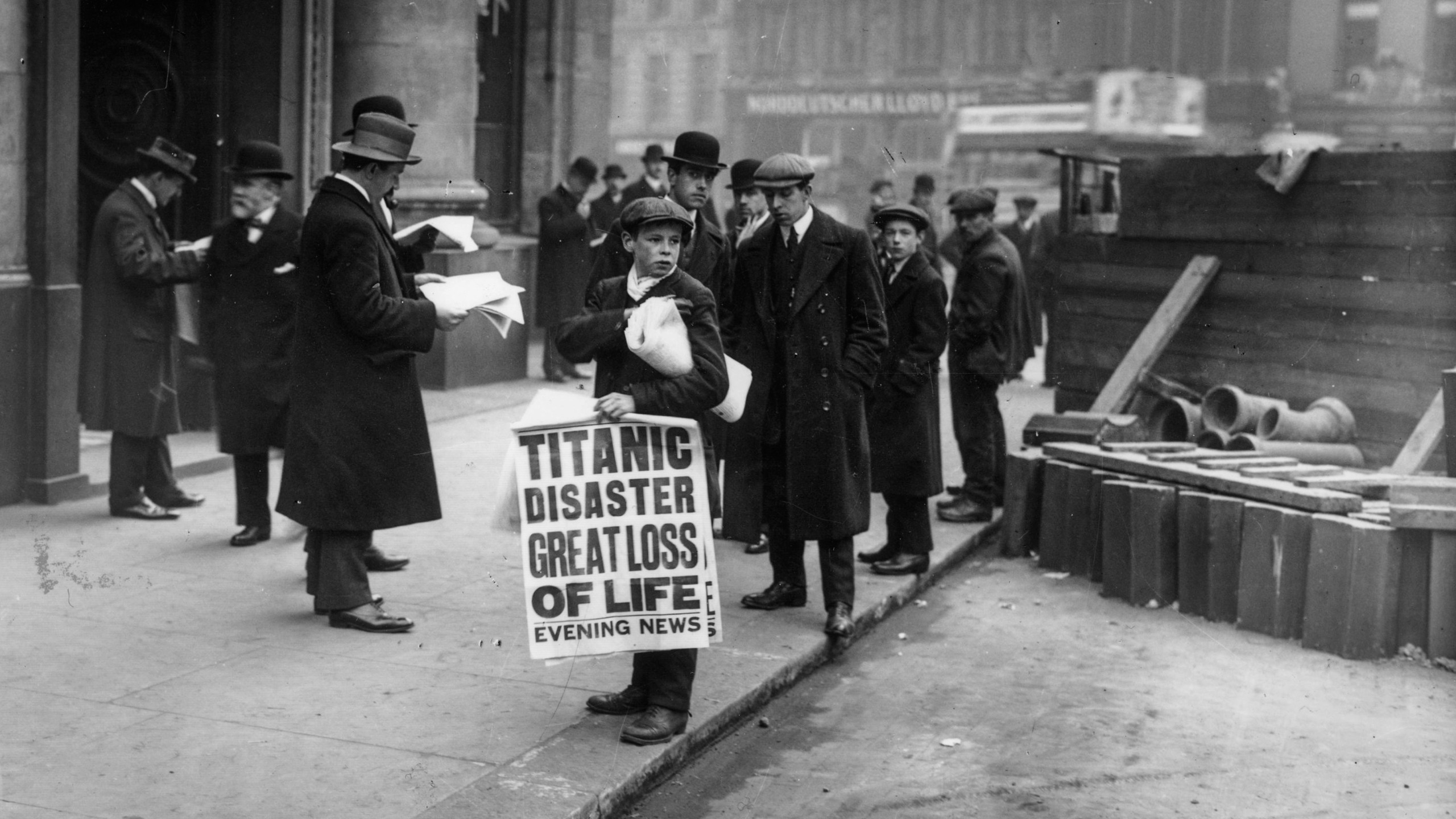 Newspaper boy Ned Parfett sells copies of the Evening News telling of the Titanic maritime disaster, outside Oceanic House, the London offices of the Titanic&rsquo;s owner, the White Star Line, in Cockspur Street, London, 16th April 1912. Six years later Parfett died whilst serving in France during World War I. He was killed in a German bombardment on 29th October 1918, 13 days before the end of the War. (Photo by Topical Press Agency/Hulton Archive/Getty Images)