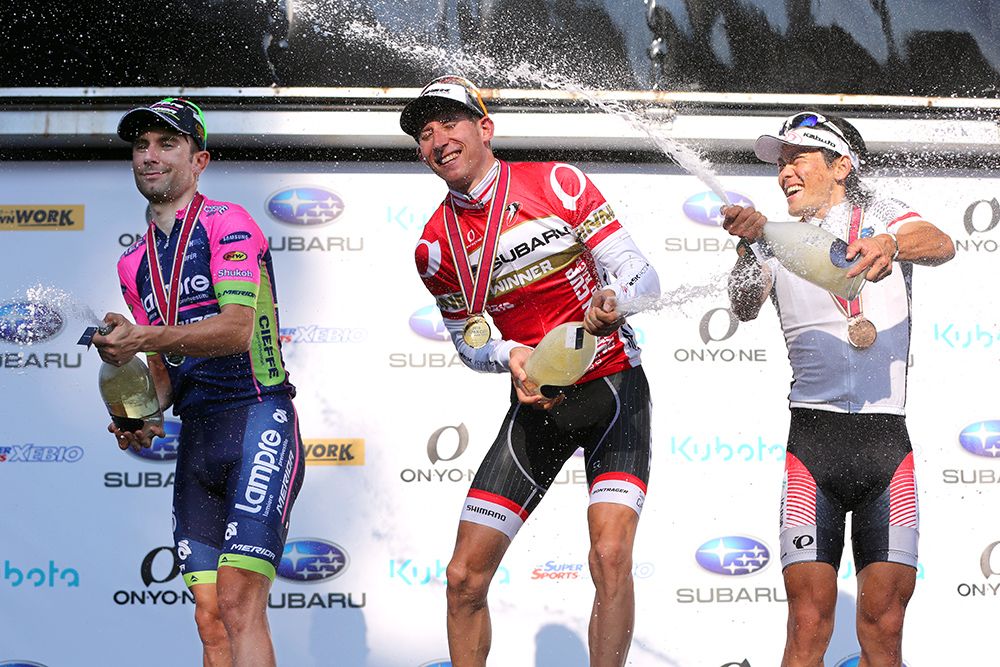 The podium riders spray the bubbly