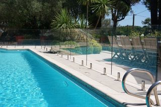 A pool with a glass structure surrounding the perimeter
