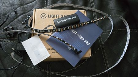 The Elgato Light Strip Pro in the box and with lighting enabled.