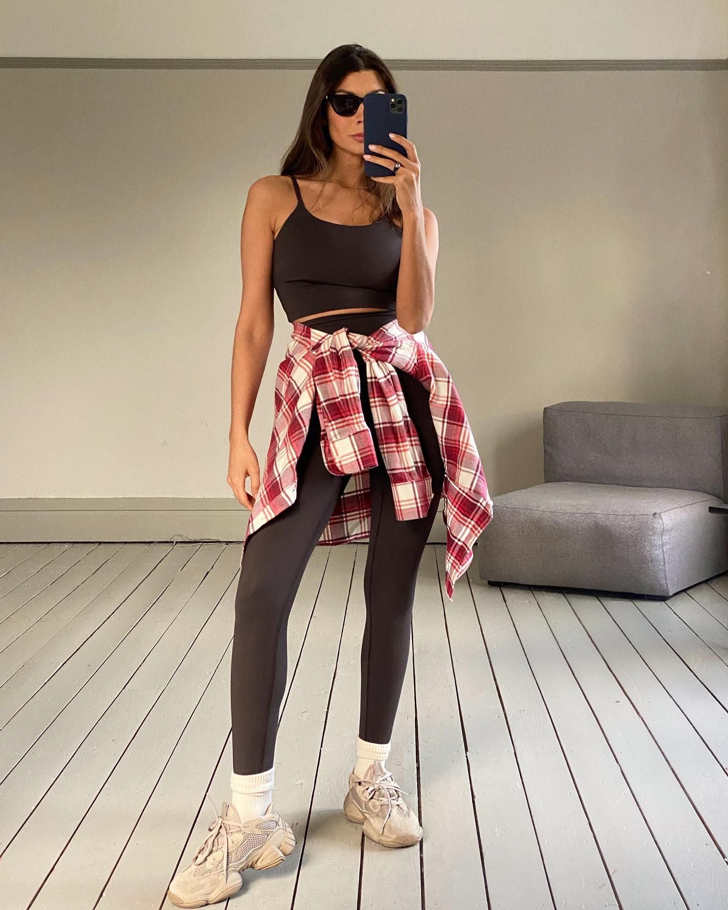 An image of @smythsisters wearing brown leggings with a red flannel shirt.