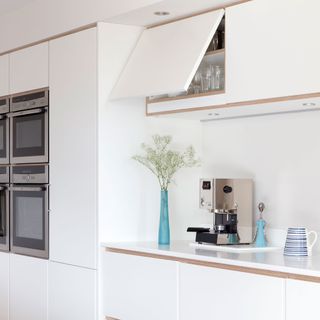 White kitchen with built in glossy cabinetry
