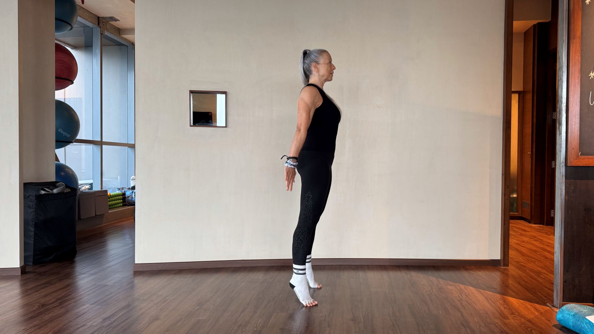 Woman demonstrates exercise in fitness studio