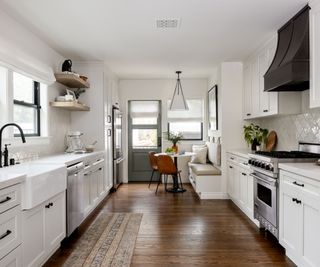 A wide galley kitchen layout with a cozy breakfast nook installed into the corner