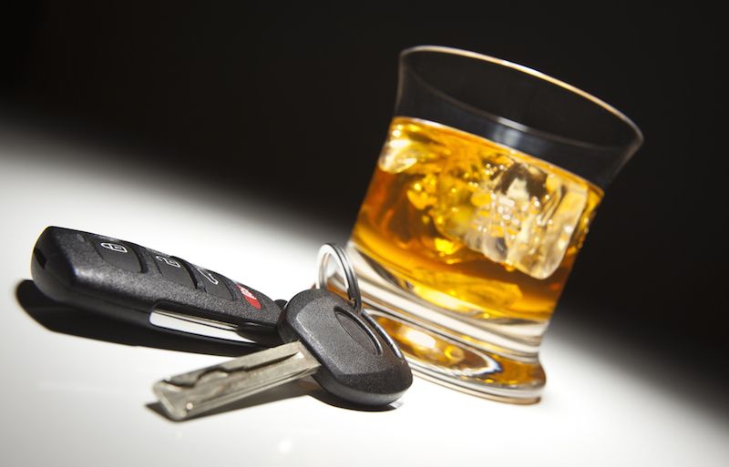 A set of car keys and a drink