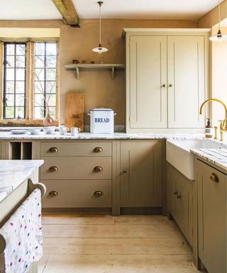 beige shaker kitchen with warm beige walls and a pantry cupboard