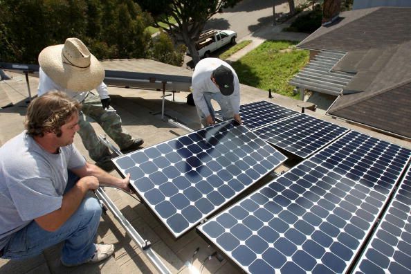 Solar panels being installed on a house.