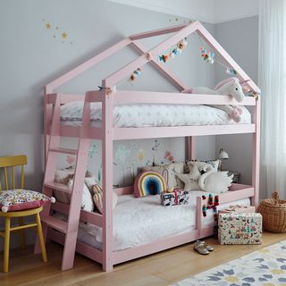 childs room with white wall and wooden flooring