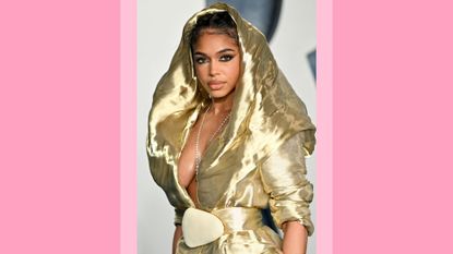 Lori Harvey wears a gold dress and hood as she attends the 2023 Vanity Fair Oscar Party Hosted By Radhika Jones at Wallis Annenberg Center for the Performing Arts on March 12, 2023 in Beverly Hills, California/ in a pink template