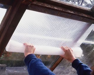 adding bubble wrap to the inside of a greenhouse