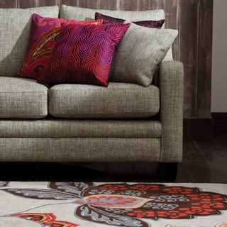 living room with grey sofa and rug