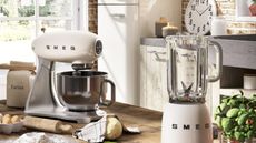 Cream Smeg appliances (a blender, stand mixer, and refrigerator) in a kitchen