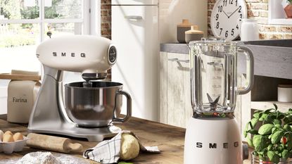 Cream Smeg appliances (a blender, stand mixer, and refrigerator) in a kitchen