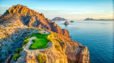 The Villa del Palmar at the Islands of Loreto golf course with the blue ocean and rock formations behind it