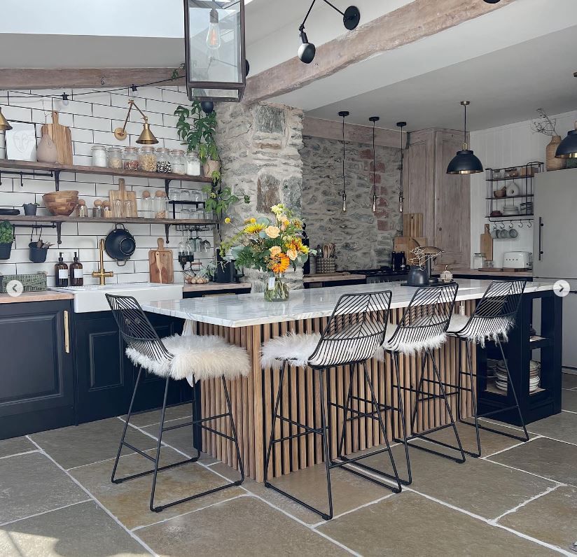A kitchen island with limestone floor tiles