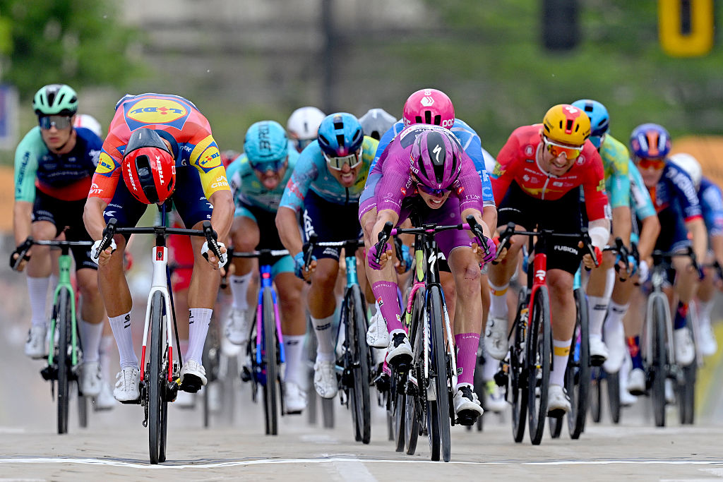 Jonathan Milan, Paul Magnier of France and Madis Mihkels sprint at finish line during the 109th Giro d'Italia