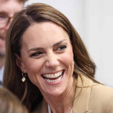 Princess Kate smiling in a tan blazer