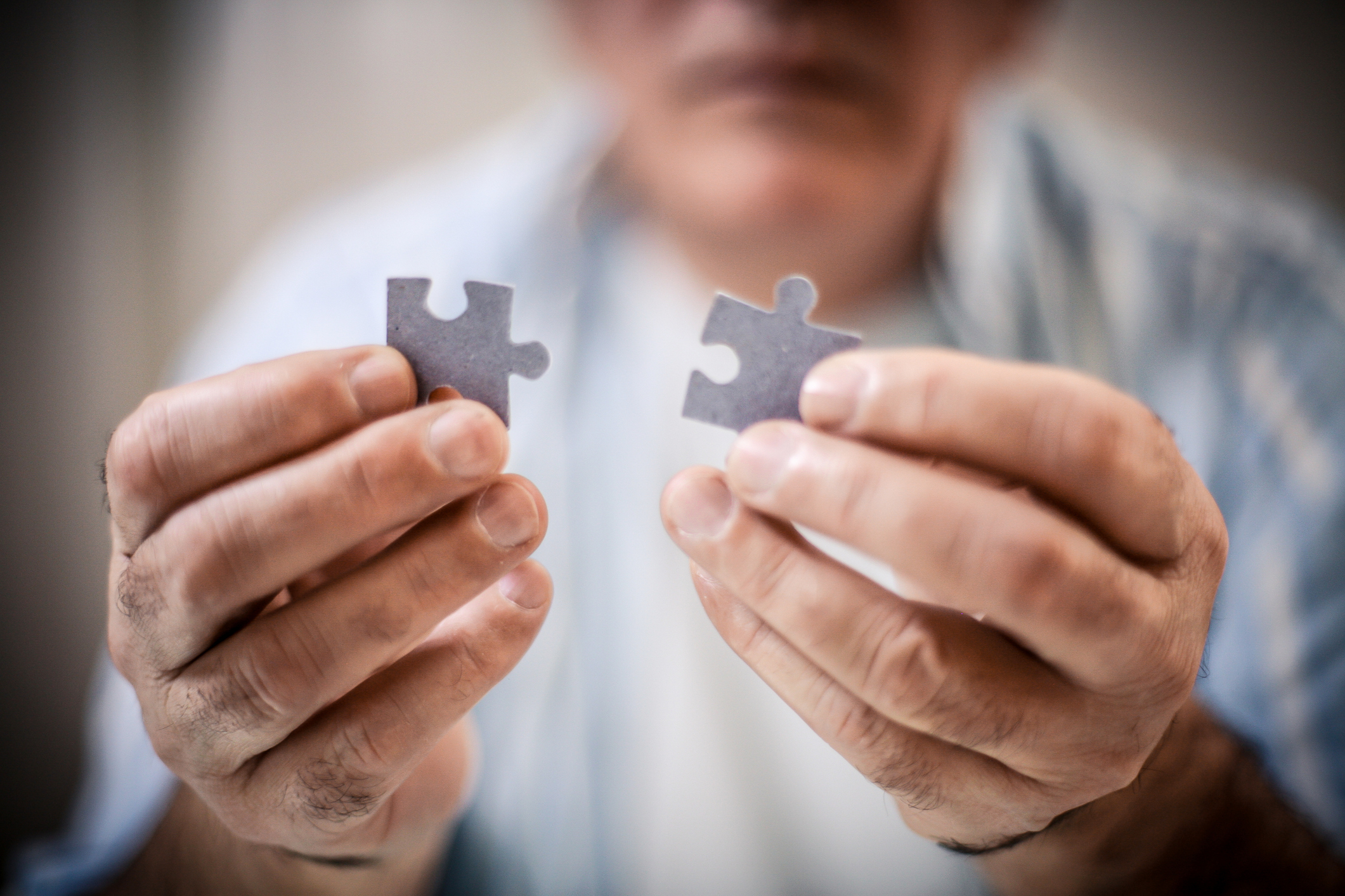 A man holding a puzzle piece 