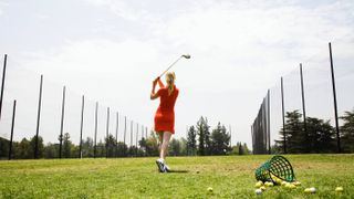 Female golfer practicing