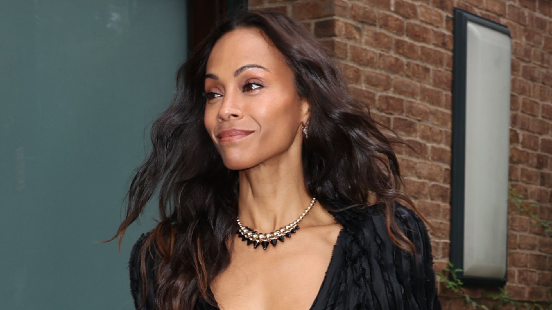 Zoe Saldana is seen on July 29, 2026, in New York City wearing a little black dress with a plunging neckline and high slit. 