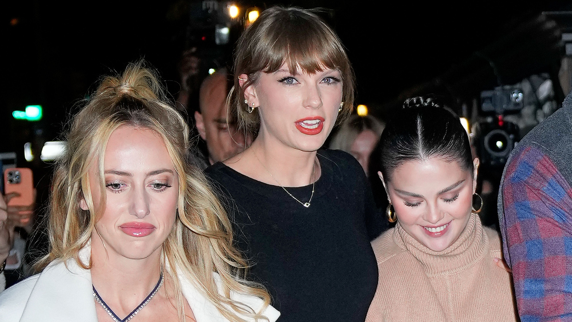 Brittany Mahomes, Taylor Swift and Selena Gomez walking down the street during a night on the town.