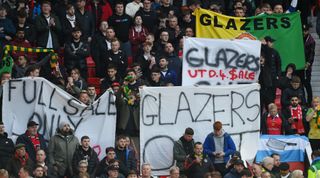 Manchester United fans protest against the club's owners, the Glazer family, ahead of the UEFA Europa League quarter-final first leg match between Manchester United and Sevilla at Old Trafford on April 13, 2023 in Manchester, United Kingdom.