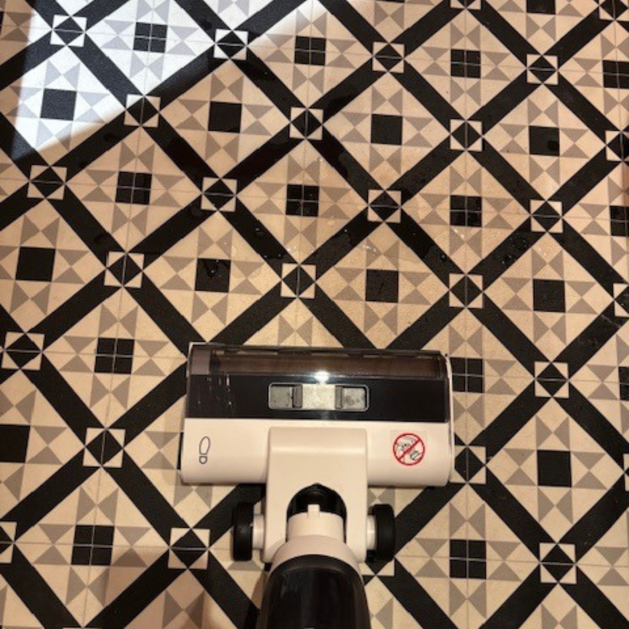 K&amp;auml;rcher Floor Cleaner Vacuum FCV 3 positioned in front of water spills on bathroom floor