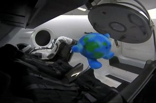 Celestial Buddies' Planetary Pal Earth plush toy floats in zero-g on board SpaceX's first Crew Dragon spacecraft to dock to the International Space Station on Sunday, March 3, 2019.