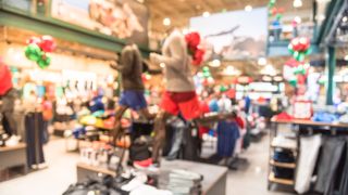 Blurred interior of sports and fitness clothing store