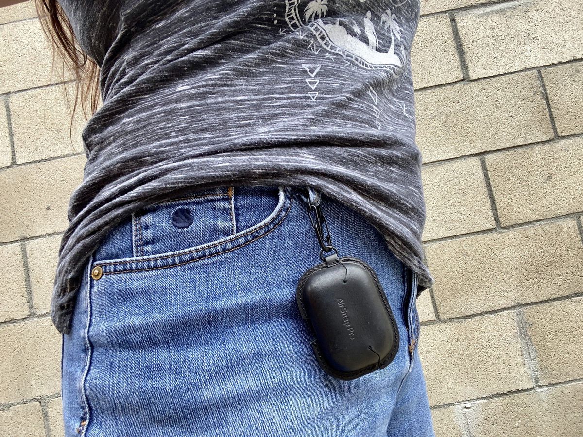Christine wears the TwelveSouth AirSnap Pro on her belt loop