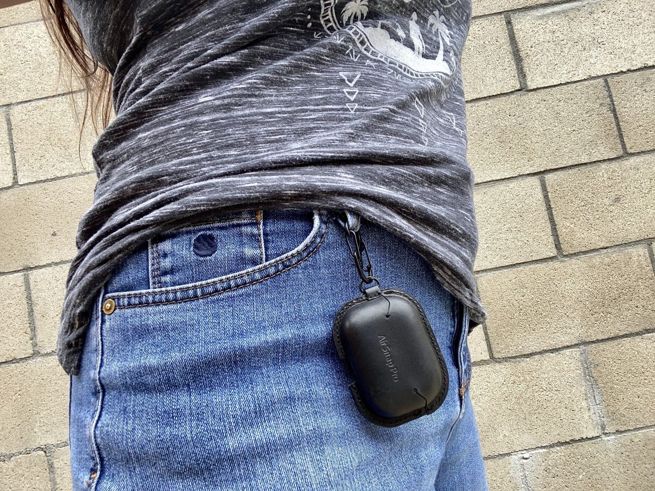Christine wears the TwelveSouth AirSnap Pro on her belt loop