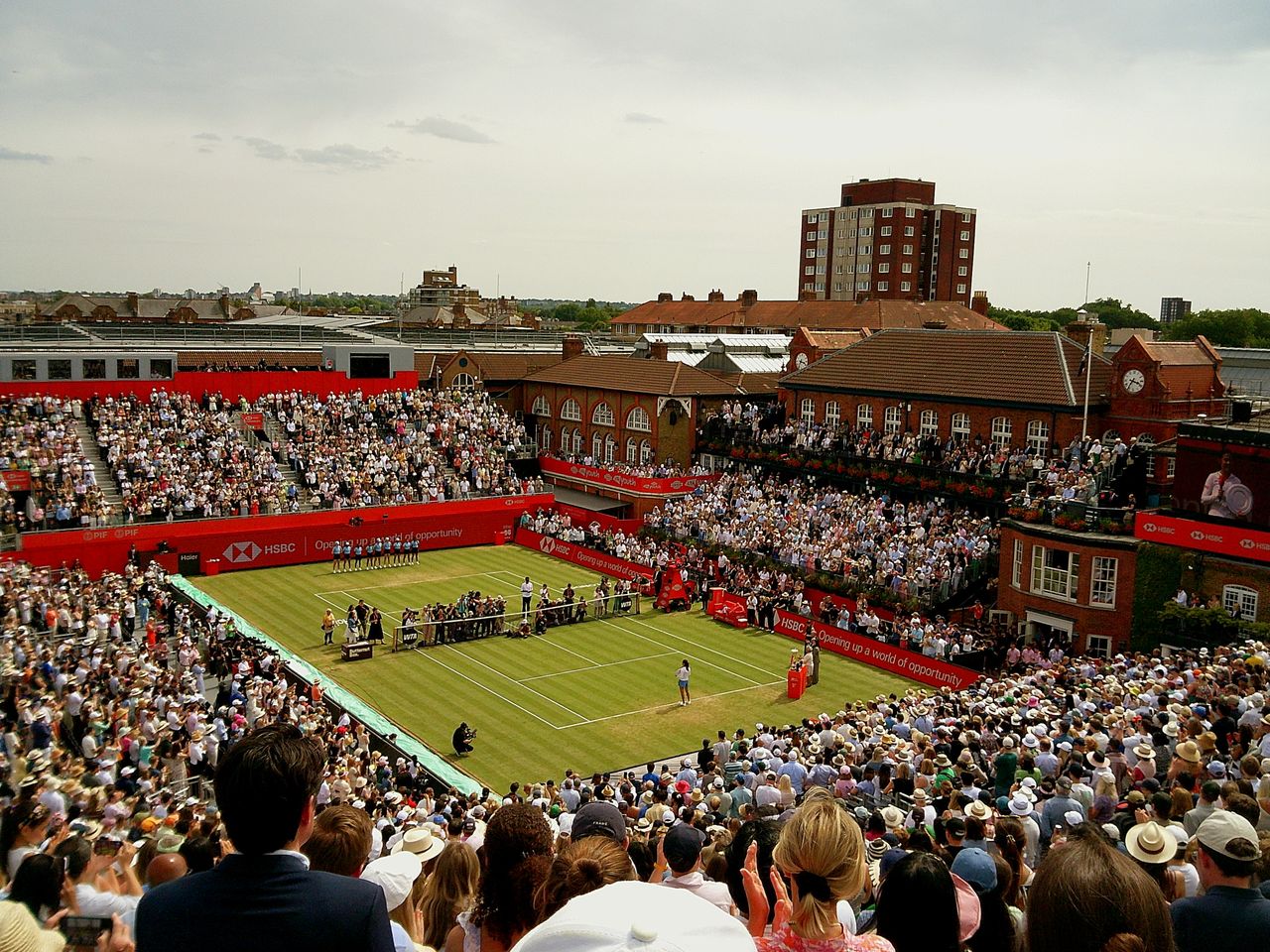 Sample image taken with Camp Snap 2 digital compact camera showing tennis court from a distance, surrounded by packed stadium