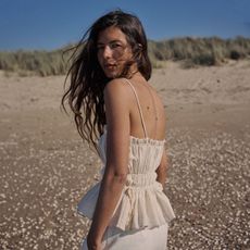 woman wearing ruched peplum top with spaghetti straps on the beach