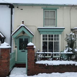 Light blue and yellow exterior of Victorian mid-terrace