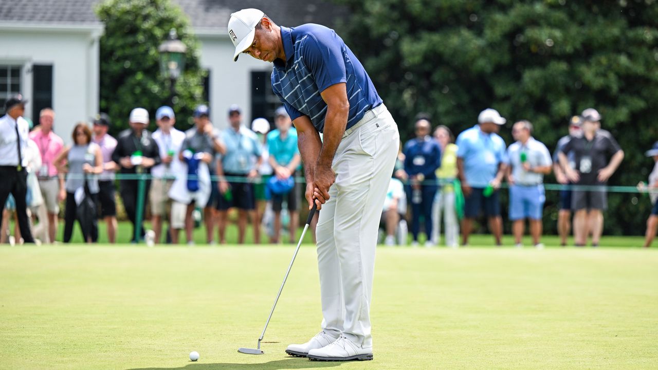 Tiger Woods hits a putt on the practice green at the 2023 Masters