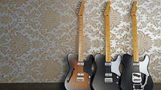 Three Fender telecasters next to each other on a wallpapered background